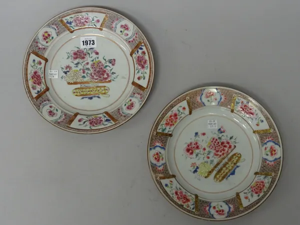 A pair of Chinese famille-rose plates, Qianlong, each painted with a central vase of flowers, inside a whorl border reserved with panels of peony, 25c