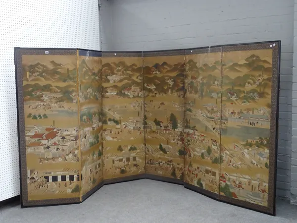 A Japanese painted paper six-fold screen, 19th century, depicting numerous figures engaged in various activities, blue ground brocade (a.f), each pane