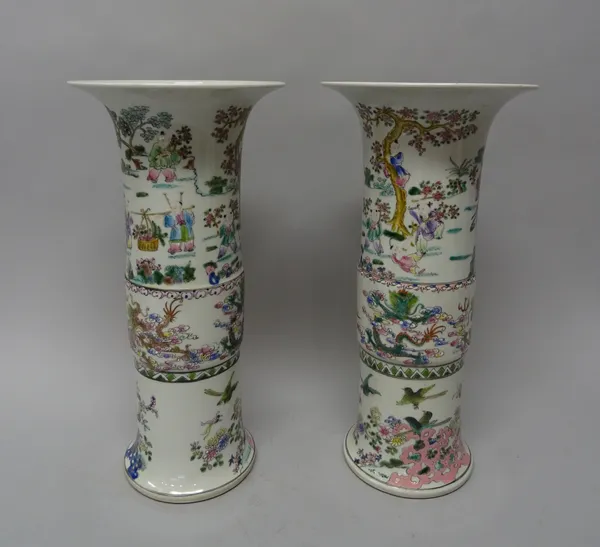 A pair of Chinese famille-rose gu vases, 20th century, each painted with figures in a landcape, dragons and birds amongst flowers apochryphal six char