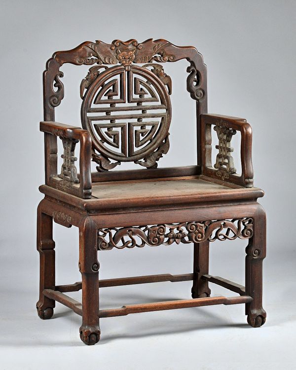 A 19th century Chinese hardwood official's chair, with 'Shou' symbol splat back, 65cm wide x 96cm high. Provenance; property from the late Sir David T