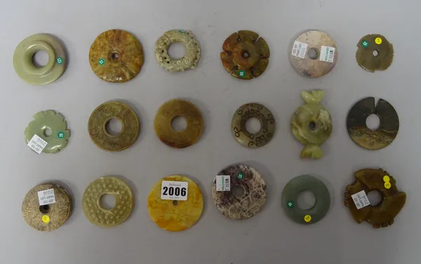 A group of fourteen Chinese archaistic jade bi discs, a jade split seal and three notched discs (xuanji), of various colours and forms,largest 7cm. wi