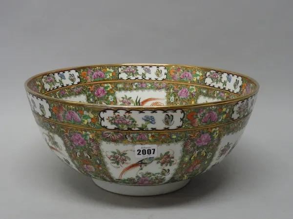 A Canton famille-rose punchbowl, 20th century, decorated with panels of birds and insects amongst flowers and fruit, against a gilt ground filled with