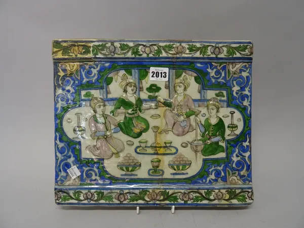 Two Qajar relief moulded tiles, Persia, late 19th century, the larger depicting princely figures drinking and listening to music, the other depicting