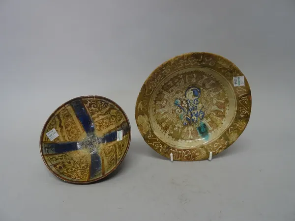 Two Kashan lustre bowls, 12th/13th century, the larger with raised foot and painted with a figurative central roundel surrounded by two bands of calli