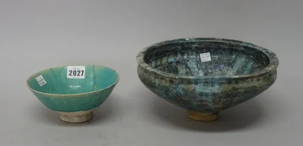 Two Kashan turquoise glazed pottery bowls, Persia, 12th/13th century, the larger with black underglaze decoration, the smaller with incised linear des