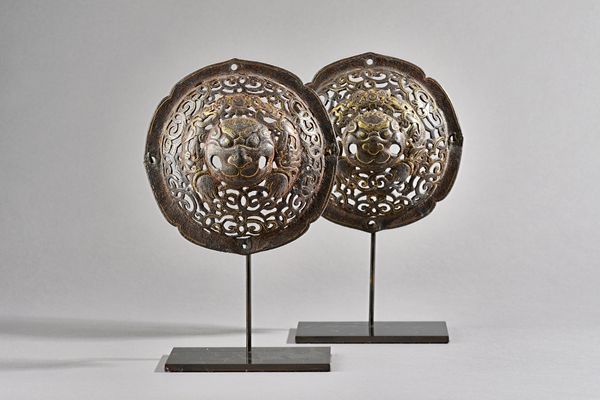 A pair of openwork door bosses, Derge, Eastern Tibet, circa 1600, steel with silver and gold damascened  openwork decoration,  of lobed circular form,