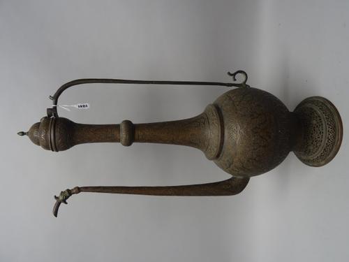 A large Kashmir engraved copper ewer, 19th century, of pear form with pierced foot, straight handle and dragon head to spout, the body with dense flor