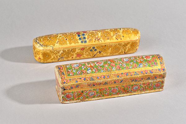 Two Kashmir polychrome painted pen boxes, circa 1900, each profusely painted with birds and flowers, 28cm. and 30cm. length, (2)