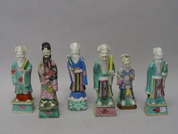 A group of six Chinese famille-rose Immortals, late 18th/early 19th century, each standing holding an attribute, mostly on rectangular plinth bases, 1