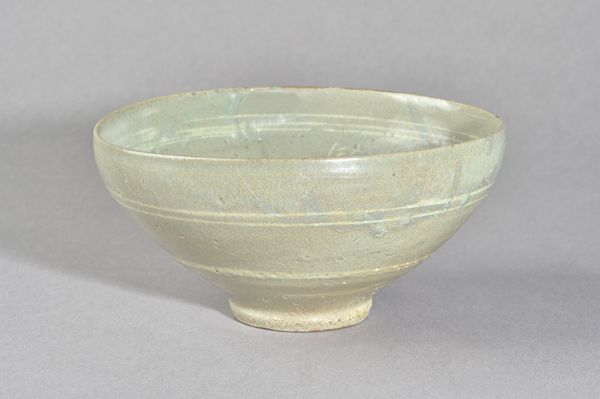 A Korean slip decorated `cranes' bowl, Goryeo dynasty (918-1392), of conical form with incised slip decoration of cranes and small birds above a band