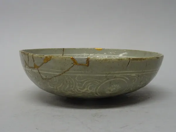 A Korean slip decorated `pomegranate' shallow bowl, Goryeo dynasty ( 918-1392), decorated with four clusters of pomegranates around a central flower p