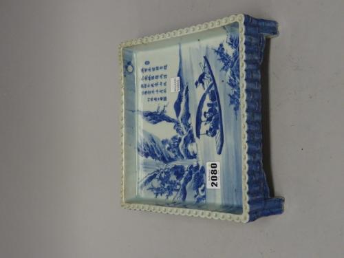 An unusual Chinese blue and white square stand, probably Republican, painted with four figures in a boat sailing down a river, the opposite bank with