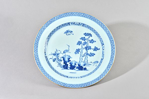 A pair of large Chinese export blue and white plates, Qianlong, each painted in the centre with three storks amongst rocks and pine trees beneath diap