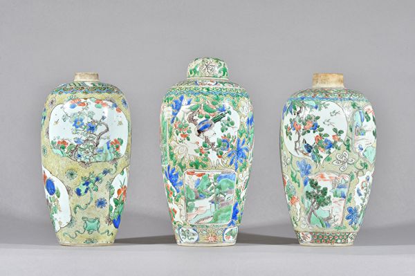 Three Chinese famille-verte ovoid vases and a cover, probably Kangxi, painted with shaped panels enclosing birds, insects, flowers and landscapes, aga