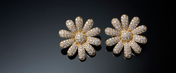 A pair of gold and diamond set earclips, each designed as a flowerhead, mounted with circular cut diamonds, the backs with folding post and clip fitti