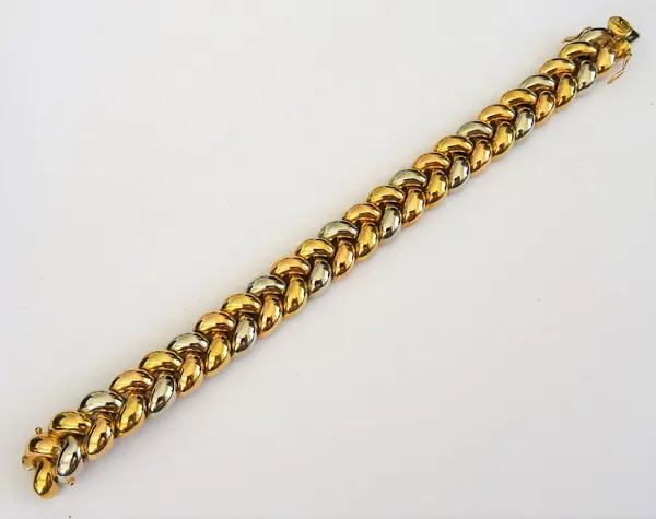 A two colour gold bracelet, in an interwoven herring bone link design, on a snap clasp, detailed Poiray 750 18 KT, length 18.3cm, weight 56 gms, with