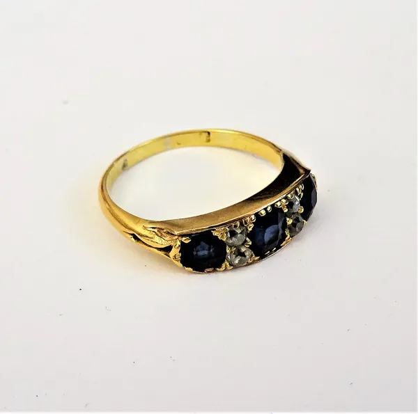 A gold, sapphire and diamond set ring, mounted with three cushion shaped sapphires alternating with two pairs of smaller cushion shaped diamonds, ring