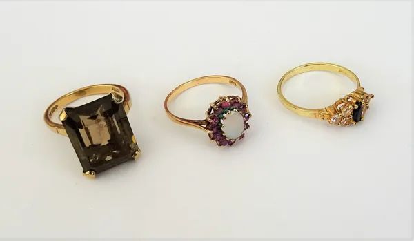 A 9ct ring, claw set with a cut cornered rectangular step cut citrine, a gold, sapphire and colourless gem set ring, detailed 585 and a 9ct gold, opal