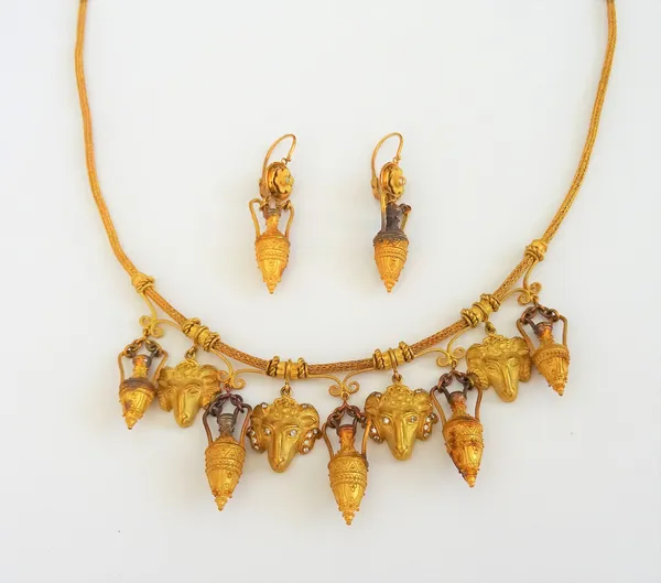 An 18ct gold and diamond Etruscan revival necklace, the front with five twin handled amphorae pendants alternating with four ram's head masks, the cen