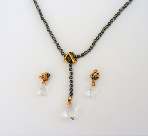 A haematite bead, diamond set and rock crystal necklace, the single row necklace of haematite beads, with a diamond topped, faceted rock crystal drop
