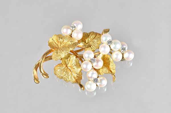 A gold, diamond and cultured pearl brooch, designed as a foliate spray, mounted with five cultured pearl set, trefoil shaped motifs, each centred by a