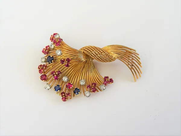 A gold, diamond, ruby and sapphire set brooch, designed as a wirework spray, claw set with circular cut diamonds and coloured gemstones, gross weight