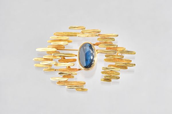 A gold and labradorite brooch, in an abstract design, having a textured finish, collet set with the oval cabochon labradorite to the centre, detailed