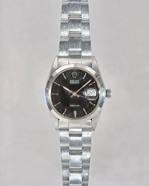 A Rolex Oysterdate Precision steel gentleman's bracelet wristwatch, the signed black dial with baton numerals, Rolex crown at 12 o'clock, centre secon