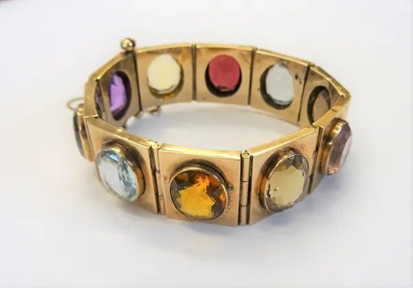 A gold and varicoloured gemstone set bracelet, formed as a row of  rectangular links, collet set with oval cut coloured gemstones, including aquamarin