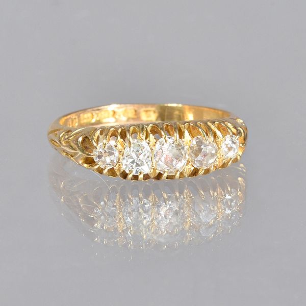 An 18ct gold and diamond set five stone ring, mounted with a row of cushion shaped idamonds, graduating in size to the centre stone, ring size O.