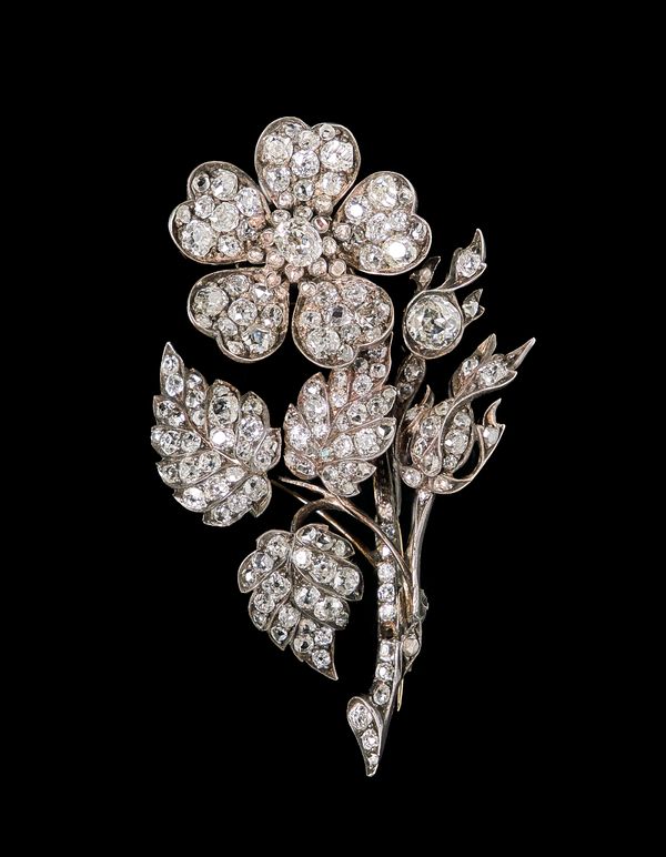 A diamond brooch, designed as a floral spray, mounted with cushion shaped and rose cut diamonds, the flowerhead en tremblant, probably mid 19th centur