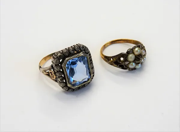 A Victorian gold rose diamond and half pearl set cluster ring, with scroll pierced shoulders, ring size I and a diamond and pale blue gem set cluster