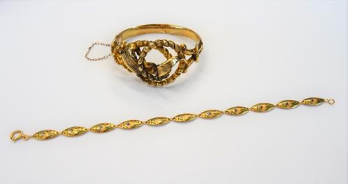 A gold oval hinged bangle, the front in an entwined design, on a snap clasp and a gold and enamelled bracelet, in an oval link design, on a boltring c