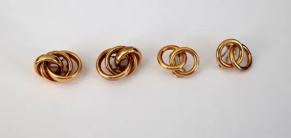 A pair of gold earclips, each in an entwined triple hoop design, detailed 750 and another pair of gold earclips, each in an entwined twin hoop design,