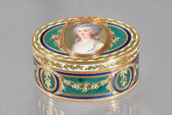 A European gold and enamelled, hinge lidded oval box, the centre mounted with an enamelled oval portrait miniature of a lady, in a ridged surround wit