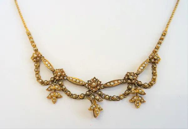 A gold and seed pearl fringe necklace, the front designed as a row of five flowerhead shaped clusters, connected by four pendant swags and with three