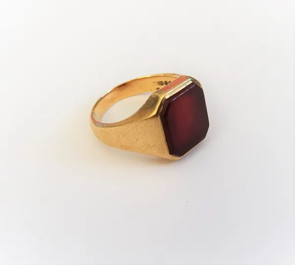 A 9ct gold and cut cornered rectangular cornelian set signet ring, London 1978, ring size N and a half, gross weight 6 gms