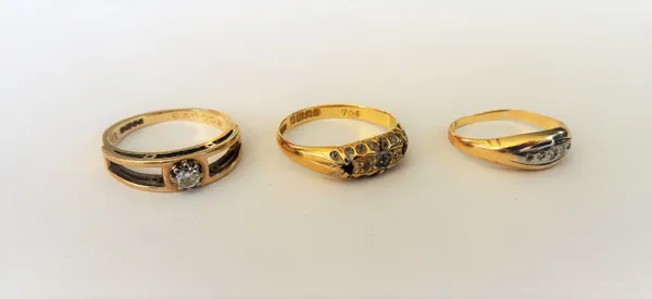 A 9ct gold and diamond single stone ring, claw set with a circular cut diamond between pierced shoulders, a gold ring set with a row of small diamonds