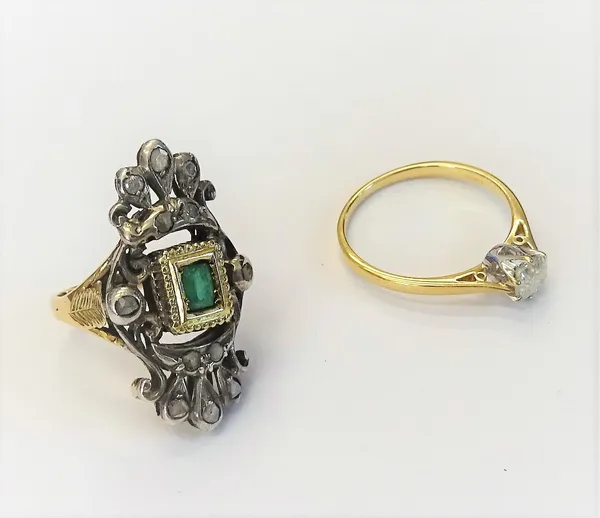 A gold and silver set emerald and diamond set ring in a pierced panel shaped design, ring size J, and a 9ct gold and diamond single stone ring, claw s