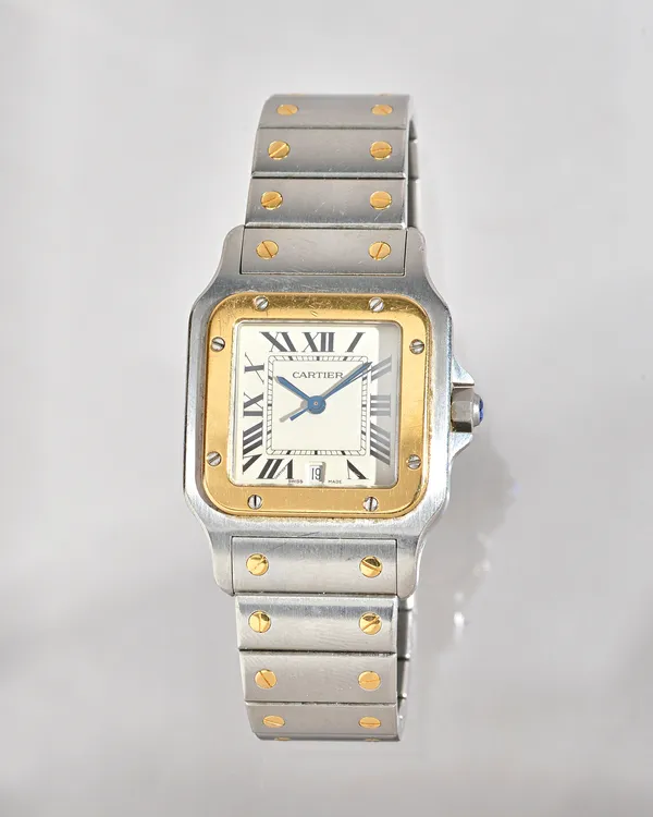 A Cartier Santos yellow gold and steel curved square cased bracelet wristwatch, with a quartz movement, the signed silvered dial with black Roman nume