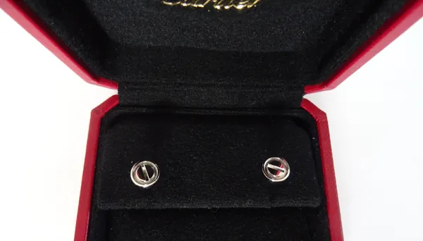 A Cartier pair of white gold Love pattern earstuds, each of circular form, with a screwhead motif, the backs with post and butterfly clip fittings, de