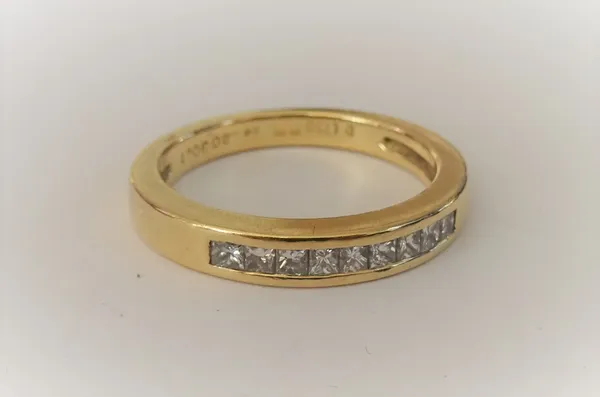 A gold and diamond ring, mounted with a row of nine princess cut diamonds, detailed 0.30ct 750, ring size L, gross weight 4.2gms.