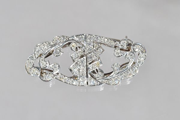 A diamond set double clip brooch, in a pierced shaped oval design, mounted with circular cut diamonds, length 4.2cm, gross weight 11.2 gms.