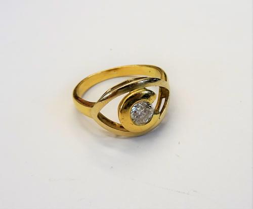 A gold and diamond single stone ring, mounted with a circular cut diamond in an open work setting, detailed 750, ring size Q 1/2, gross weight 5.5 gms