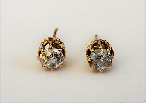 A pair of gold and diamond set single stone earstuds, each claw set with a cushion shaped diamond, the backs with post fittings, (the butterfly clips