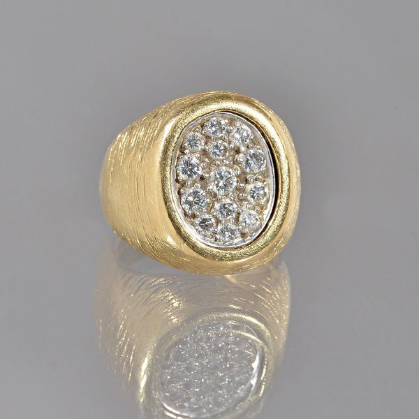 A Kutchinsky 18ct gold and diamond ring, in an oval panel shapped design, mounted with circular cut diamonds, with a textured finish, gross weight 22.