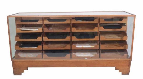 Dudley & Co Ltd; a mid-20th century oak haberdashery cabinet, glazed top and front enclosing twelve drawers, 178cm wide x 91cm high x 58cm deep.  Prov