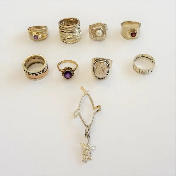 A 9ct gold ring, collet set with an oval cut amethyst in a ribbon twist surround, ring size L and mostly silver jewellery, comprising; seven rings and