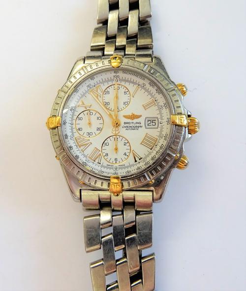 A Breitling Chronograph Automatic gentleman's steel bracelet wristwatch, the signed white dial with three subsidiary dials, date of the month aperture