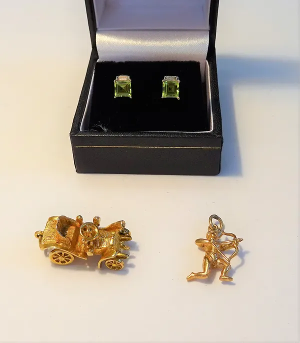A pair of 9ct gold, peridot and diamond earstuds, each mounted with a square cut peridot and with a single baguette diamond above, the backs with post